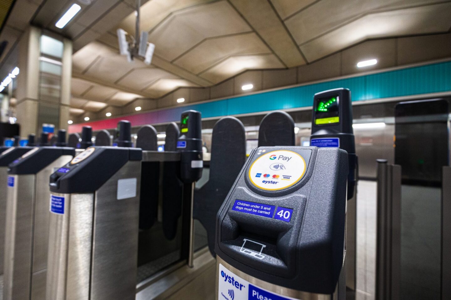 Ticket barrier representing London travel fares, charges, and savings